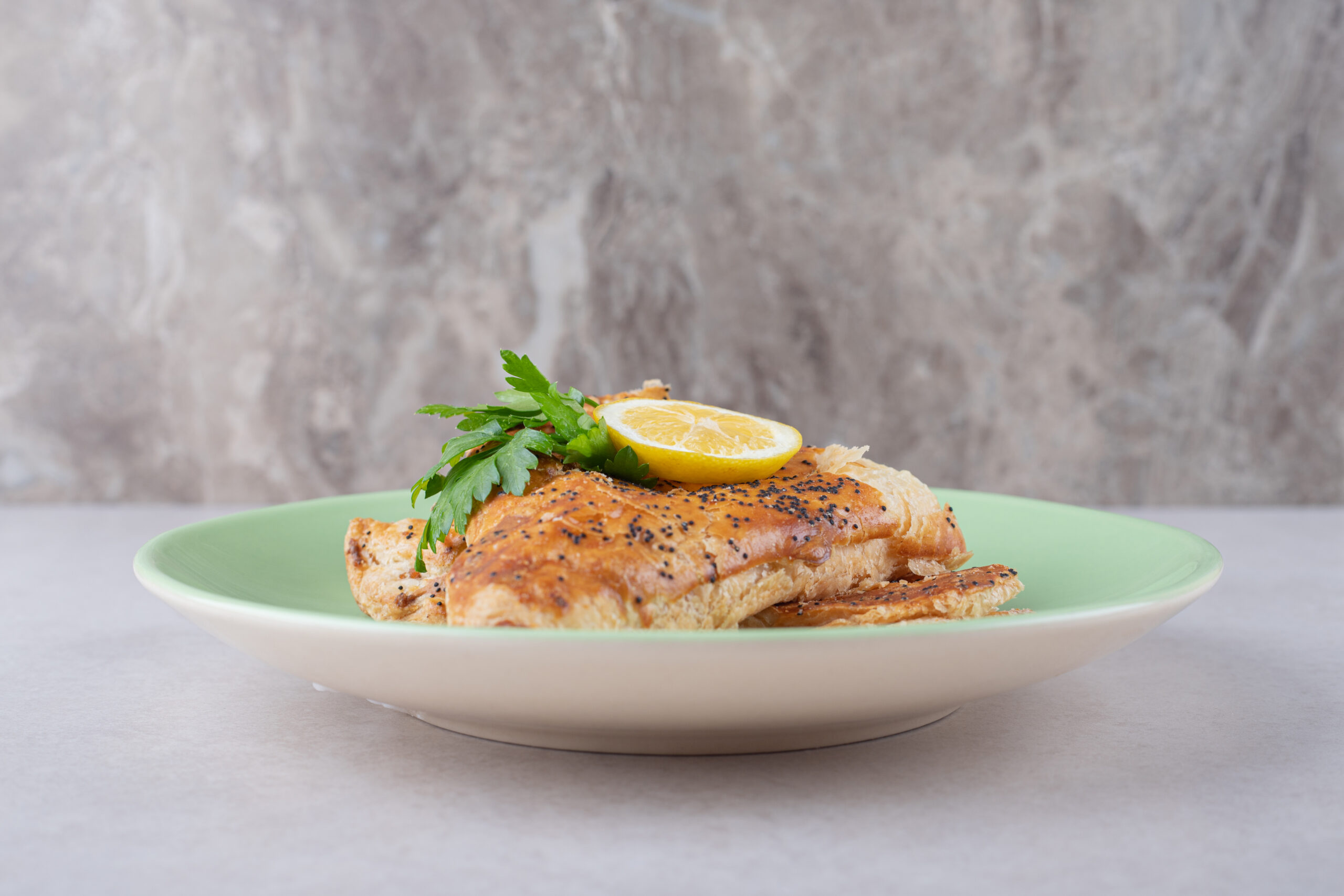 Ramadan pita with slice lemon on plate, on the marble background. High quality photo